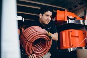 water damage restoration technician taking equipment out of vehicle