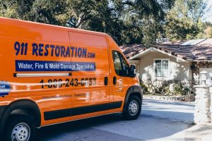 sewage backup cleanup vehicle parked in front of house