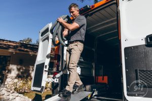 disaster restoration technician taking equipment out of van